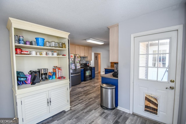 kitchen featuring a textured ceiling, dark hardwood / wood-style floors, stainless steel fridge, black range with electric stovetop, and light brown cabinets