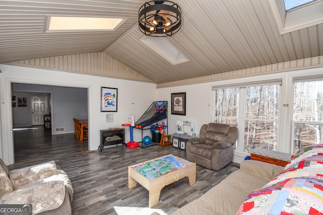 living room with dark wood-type flooring and vaulted ceiling with skylight