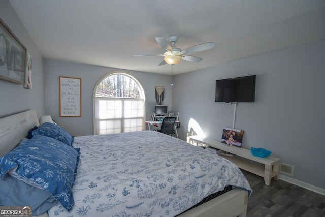 bedroom featuring ceiling fan and dark wood-type flooring