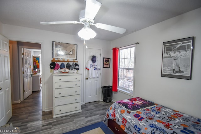 bedroom featuring ceiling fan, a closet, and dark hardwood / wood-style floors