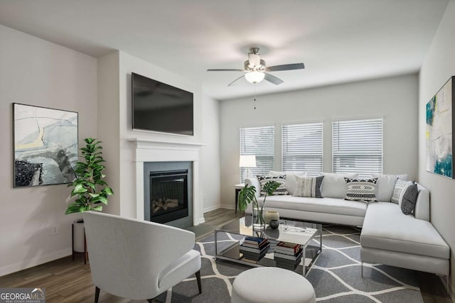 living room with ceiling fan and dark hardwood / wood-style flooring