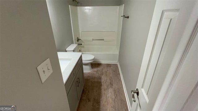 full bathroom featuring hardwood / wood-style floors, vanity,  shower combination, and toilet