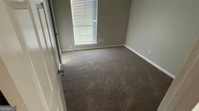 unfurnished room featuring carpet