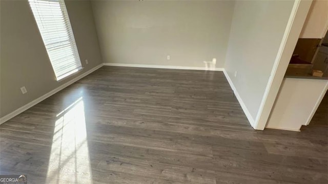 spare room featuring dark hardwood / wood-style flooring