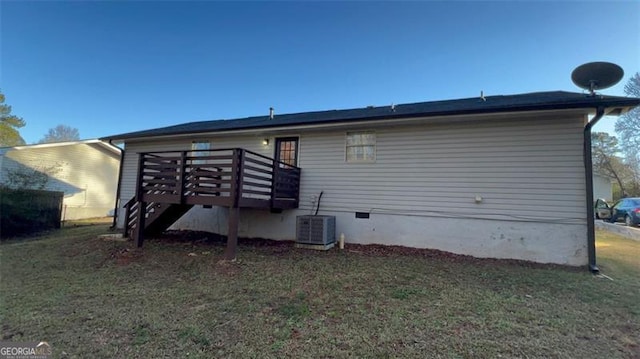 back of house with a lawn, central AC unit, and a wooden deck