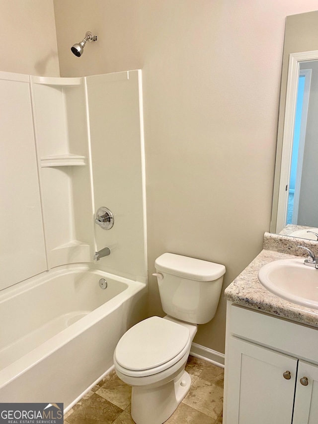 full bath featuring toilet,  shower combination, vanity, and baseboards