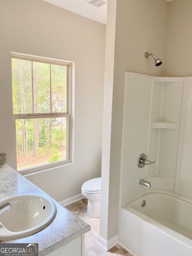 full bathroom featuring toilet, baseboards, shower / bathing tub combination, and vanity