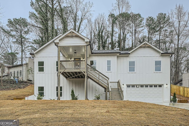 rear view of property featuring a garage and a yard