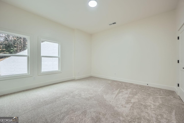 unfurnished room featuring light colored carpet