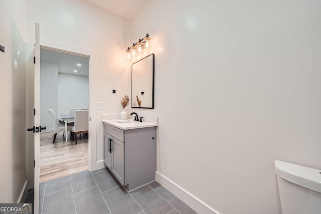 bathroom featuring tile patterned flooring, vanity, and toilet