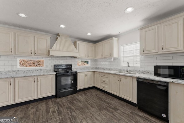 kitchen with custom exhaust hood, dark hardwood / wood-style floors, black appliances, cream cabinetry, and sink