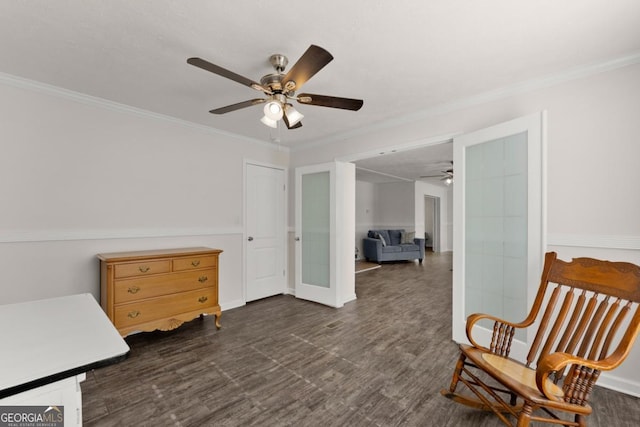 living area featuring french doors and crown molding