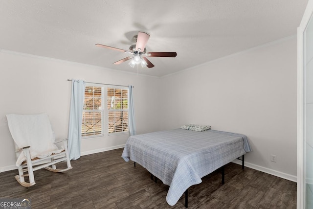 bedroom featuring ceiling fan, dark hardwood / wood-style flooring, and crown molding