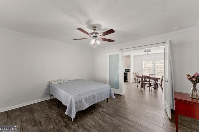 bedroom with ornamental molding, a textured ceiling, ceiling fan, and dark hardwood / wood-style flooring