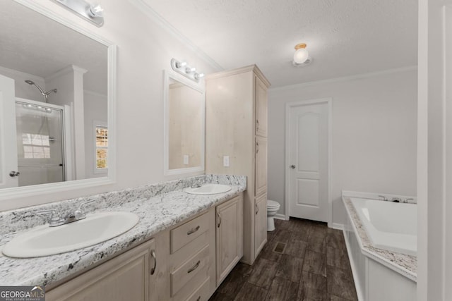 full bathroom featuring a textured ceiling, toilet, vanity, crown molding, and plus walk in shower