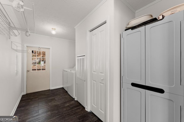 hall with a textured ceiling, separate washer and dryer, crown molding, and dark hardwood / wood-style floors