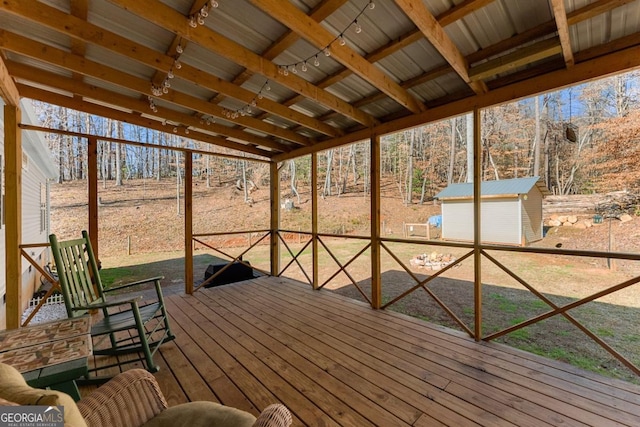 unfurnished sunroom with rail lighting