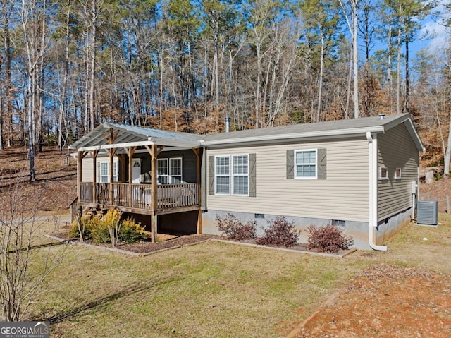 view of front of property with cooling unit and a front lawn