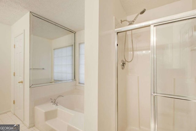 bathroom featuring tile patterned flooring, a textured ceiling, and independent shower and bath