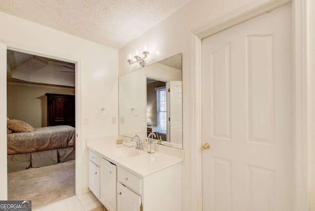 bathroom featuring tile patterned flooring, vanity, and a textured ceiling