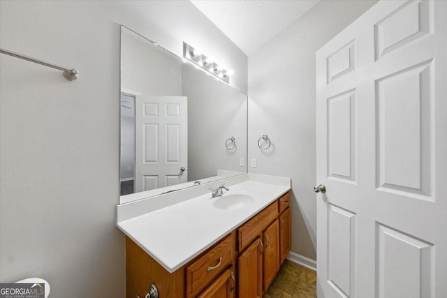 bathroom featuring vanity and baseboards