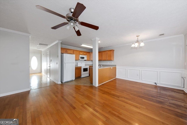 unfurnished living room featuring ornamental molding, visible vents, dark wood finished floors, and a textured ceiling