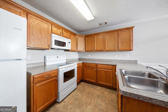 kitchen with ornamental molding, white appliances, brown cabinetry, and a sink