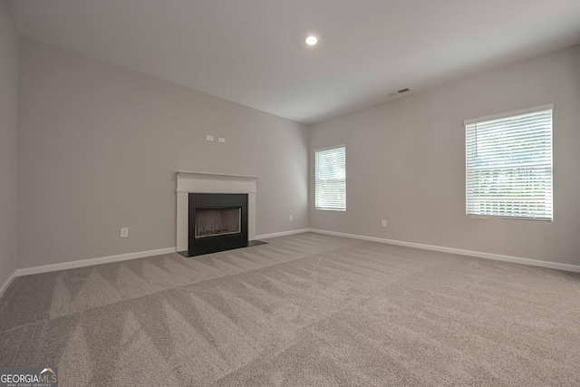 unfurnished living room featuring carpet flooring