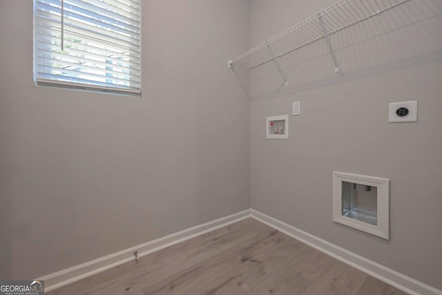 clothes washing area featuring hookup for a washing machine, hardwood / wood-style flooring, and hookup for an electric dryer