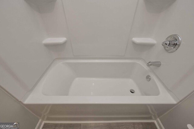 full bathroom featuring wood-type flooring, toilet, shower / washtub combination, and vanity