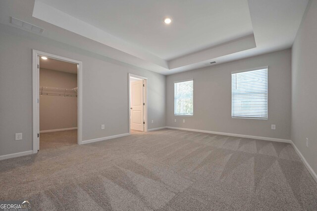 empty room featuring vaulted ceiling and carpet