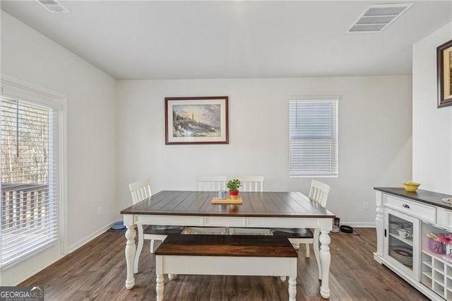 dining area with dark hardwood / wood-style flooring