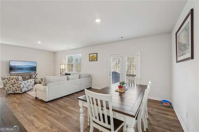 dining room with hardwood / wood-style floors and a wealth of natural light