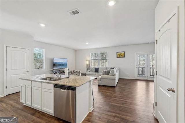 kitchen with sink, white cabinetry, an island with sink, stainless steel dishwasher, and a wealth of natural light