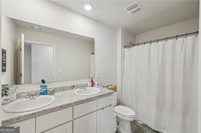 bathroom with toilet and vanity