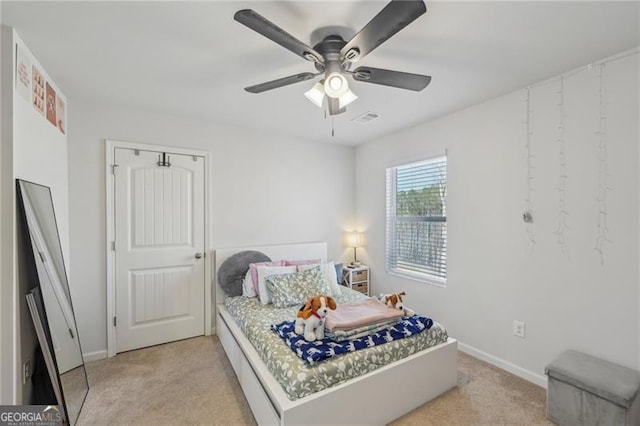 bedroom with ceiling fan and light colored carpet