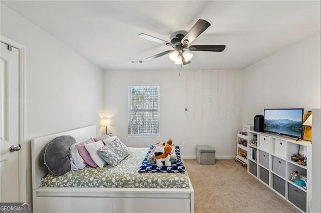 bedroom featuring light carpet and ceiling fan