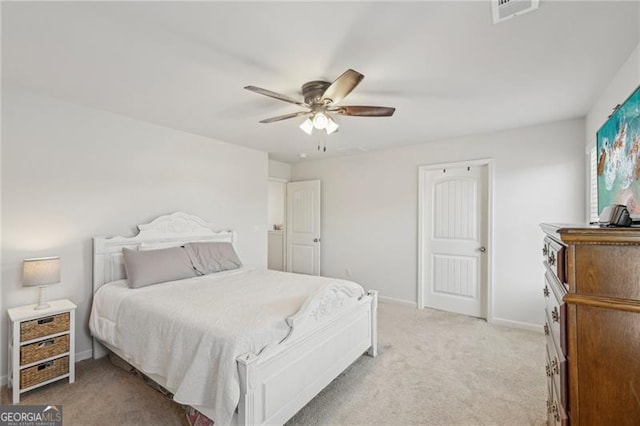 bedroom with ceiling fan and light carpet