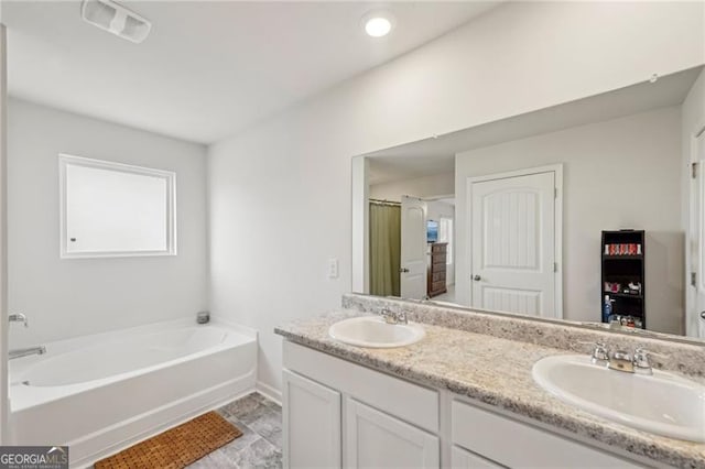 bathroom featuring a bath and vanity