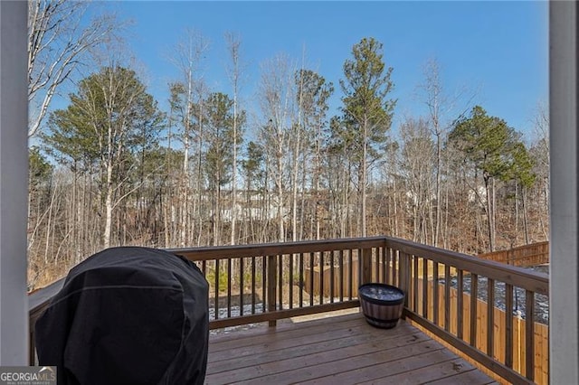 wooden deck featuring a grill