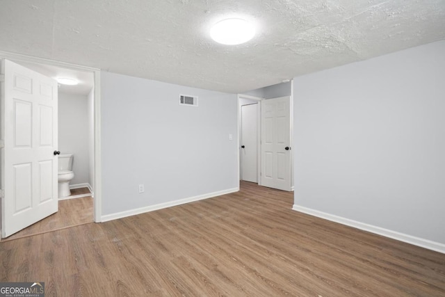 interior space with hardwood / wood-style floors and a textured ceiling