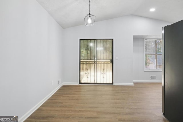 interior space with wood-type flooring and lofted ceiling