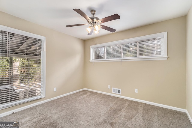 spare room with ceiling fan and carpet flooring