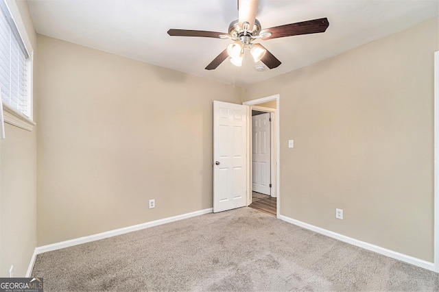 unfurnished bedroom with carpet floors and ceiling fan