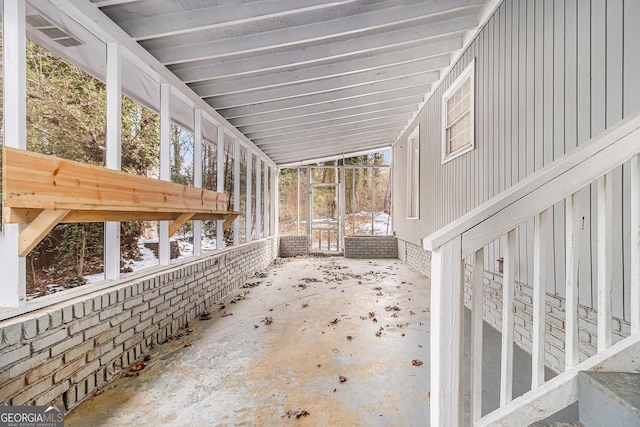 unfurnished sunroom with vaulted ceiling and plenty of natural light