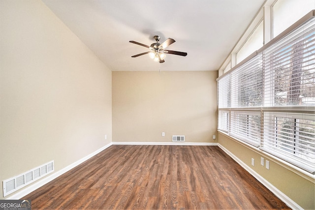 spare room featuring ceiling fan and dark wood-type flooring