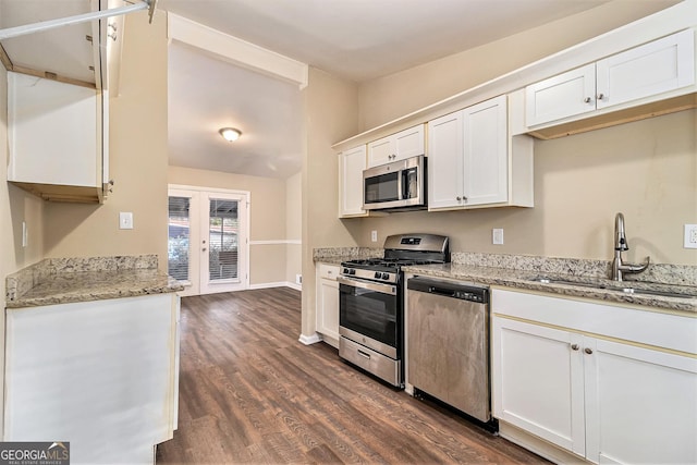 kitchen with sink, stainless steel appliances, french doors, and white cabinets