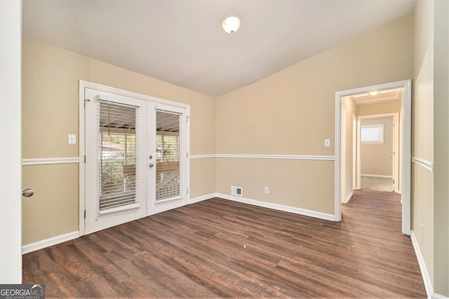 unfurnished room with dark hardwood / wood-style flooring, french doors, and vaulted ceiling