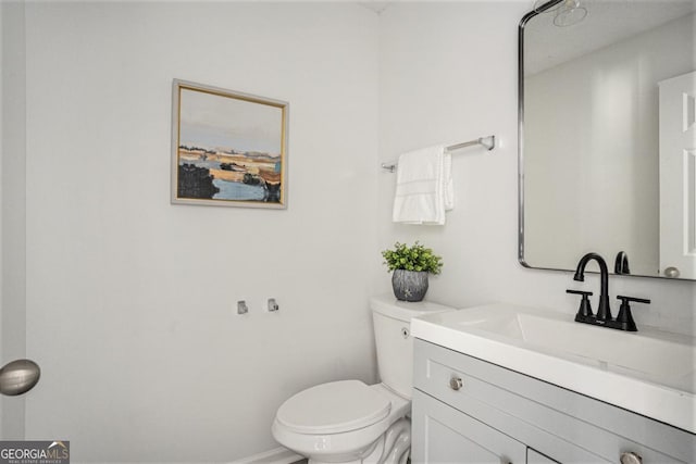 bathroom featuring vanity and toilet