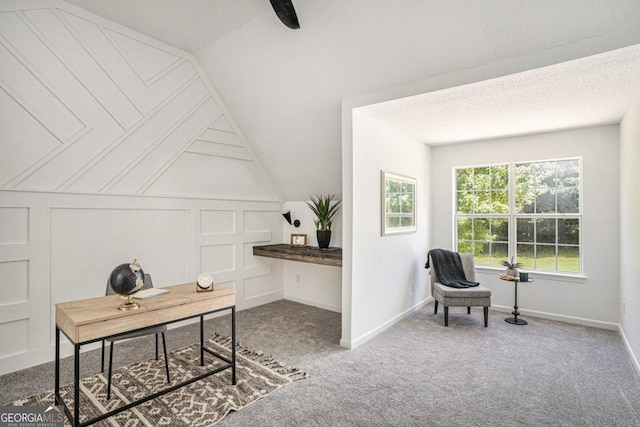 carpeted office featuring vaulted ceiling